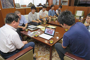 Gifu University team members reporting their winning to the President