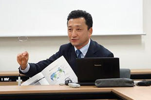 Mr. Saigusa making a presentation