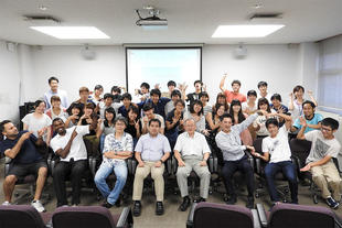 Group photo with summer program participants, international TAs, and university staff.