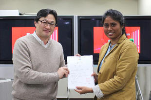 A student with her certificate