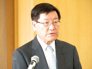 President Hisataka giving a speech